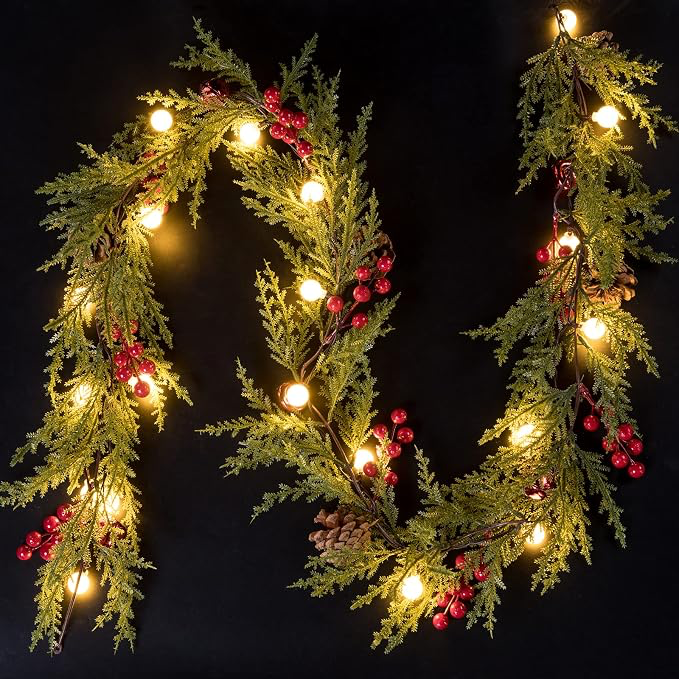 6 ft Christmas evergreen garland with 40 glowing globe lights, natural-look pinecones and red berry clusters against a dark background