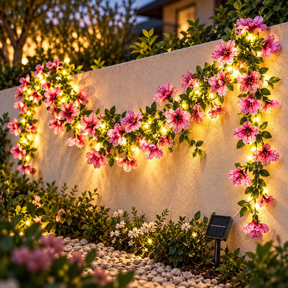 Solar violet flower fairy string lights draped on an outdoor garden wall at dusk