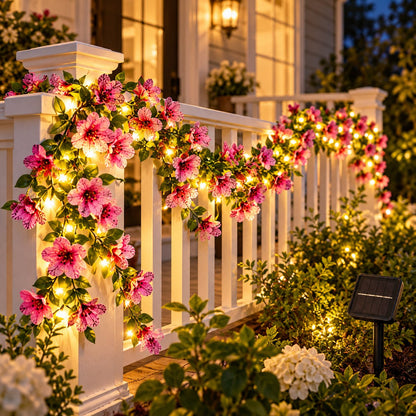 Pink violet flower solar fairy lights draped over a white porch railing at twilight